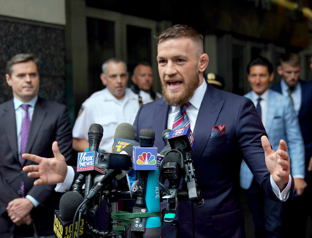 Conor McGregor talks to the press after he pleaded guilty to a single violation of disorderly conduct, in Brooklyn Criminal Court.