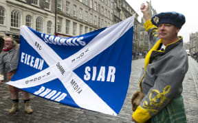 Pro-independence voters march down Edinburgh's Royal Mile to protest Scotland's referendum results.