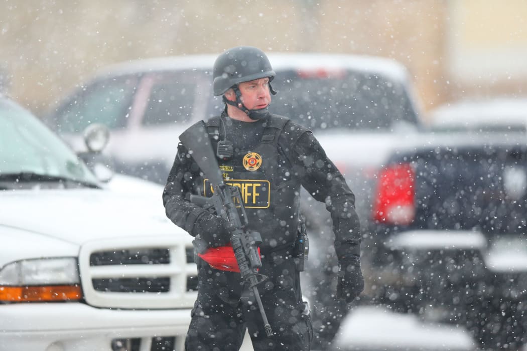 A member of the Colorado Springs sheriff's department secures the scene during an active shooter situation near a Planned Parenthood facility where an unidentified suspect has reportedly injured up to nine people, including at least four police officers, on November 27.