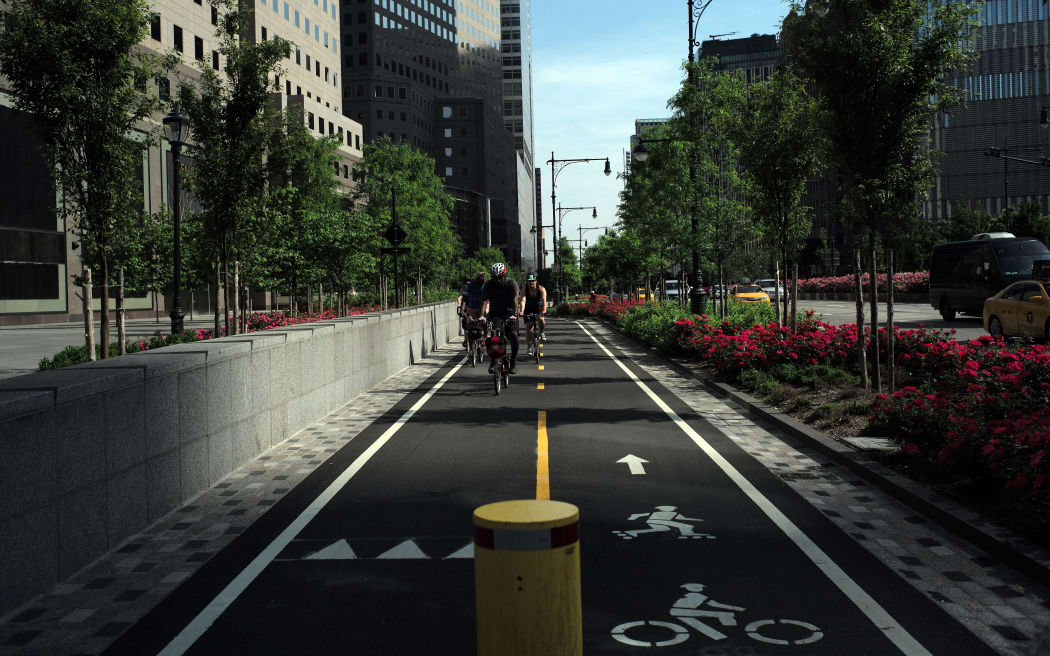 A group of cyclists ride along a dedicated bike lane in downtown Manhattan on May 29, 2016 in New York.