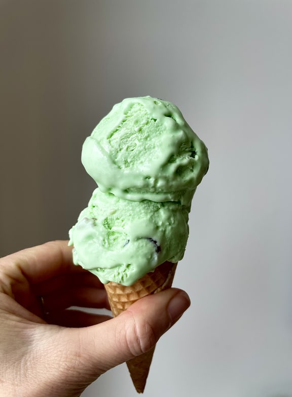 Homemade Goody Jamdrop Ice Cream - Close-up of hand holding a cone with two scoops on top