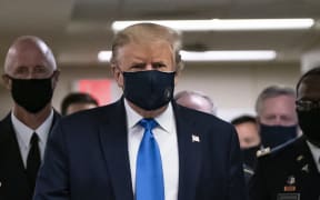 US President Donald Trump wears a mask as he visits Walter Reed National Military Medical Center in Bethesda, Maryland.