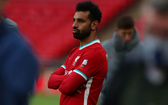 A dejected Mohamed Salah of Liverpool watches on.