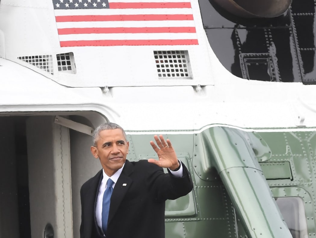 Former President Barack Obama waves as boards a helicopter to depart the US Capitol after inauguration ceremonies at the US Capitol in Washington, DC, on January 20, 2017.