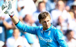 England cricketer Joe Root raises his bat.