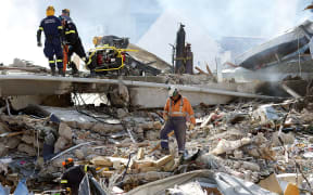 Rescuers work at the smoking ruins of the CTV building.