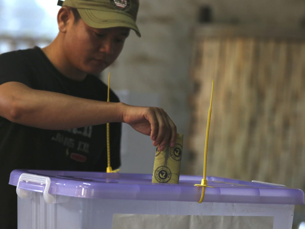 A voter casts his ballot at a polling station in Myanmar's Rakhine state.
