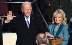 Joe Biden (L), flanked by incoming US First Lady Jill Biden is sworn in as the 46th US President by Supreme Court Chief Justice John Roberts on January 20, 2021, at the US Capitol in Washington, DC.