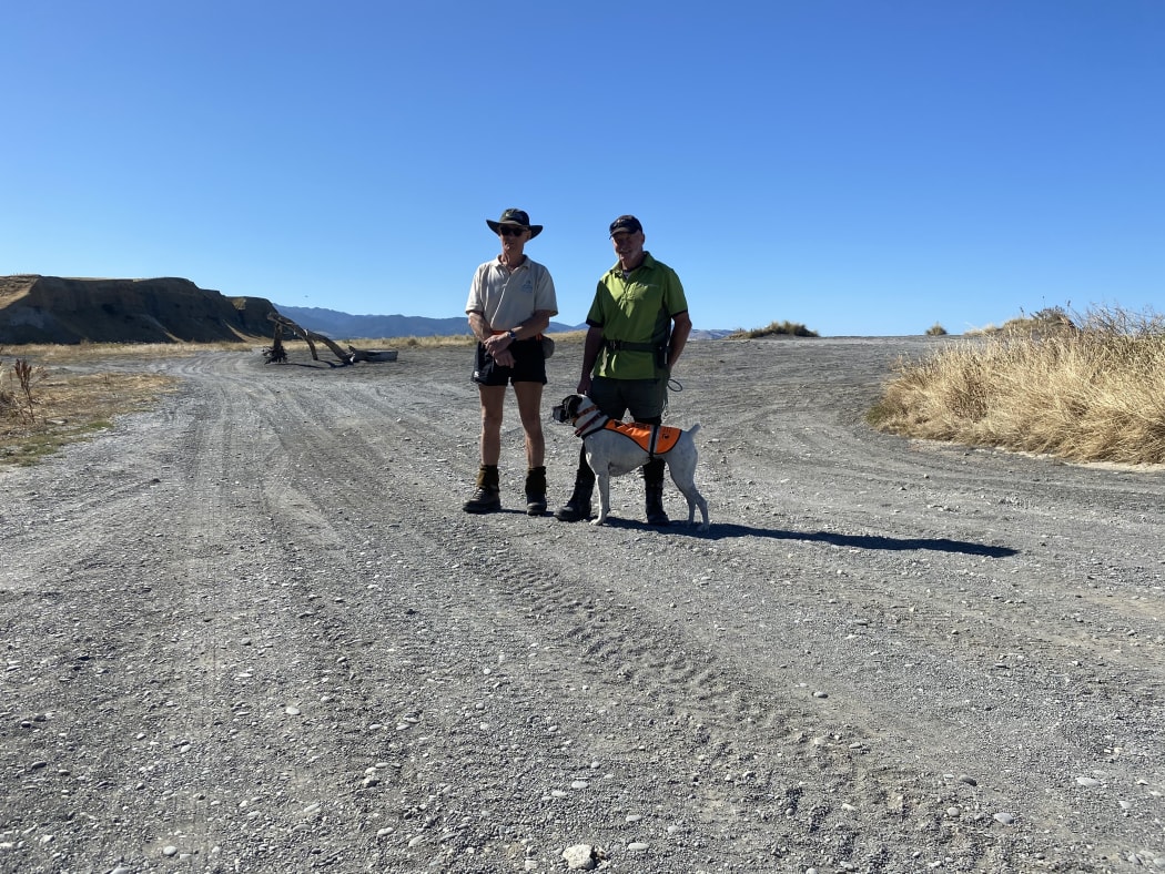 Bailey, a sniffer dog and part of the Conservation Dogs Programme, at Okorewa Lagoon, South Wairarapa, with handler Graeme Miller [right], and Kevin Stephens, of Greater Wellington Regional Council.