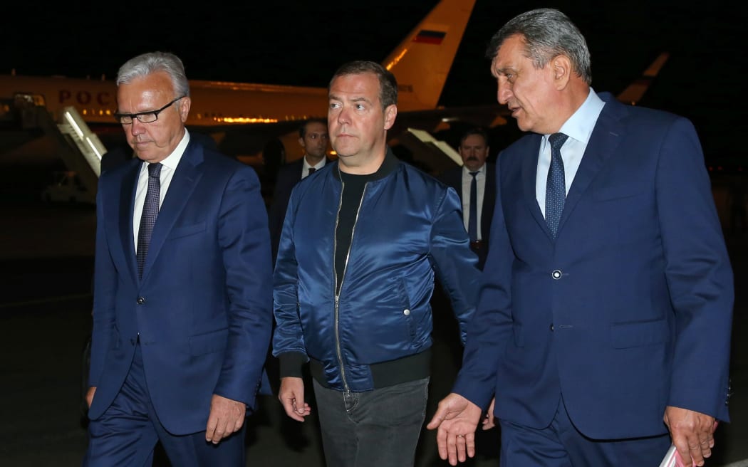 Russian Prime Minister Dmitry Medvedev is welcomed by presidential envoy in the Siberian Federal District Sergey Menyaylo and governor of Krasnoyarsk Region Alexander Uss upon his arrival at the airport of Krasnoyarsk, Russia.