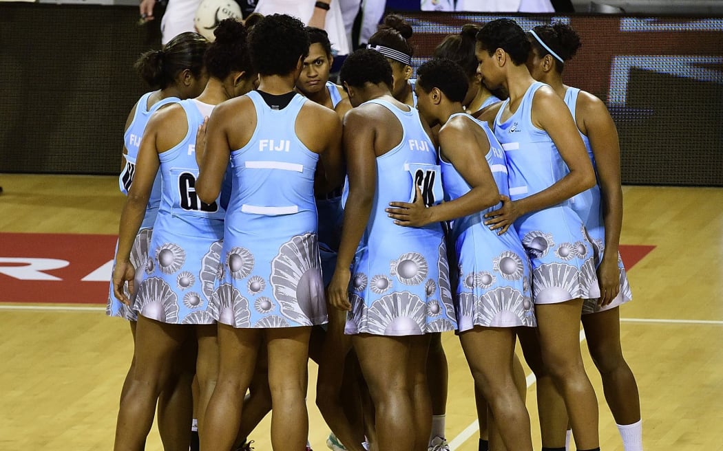 The Fiji netball team in discussion on court.