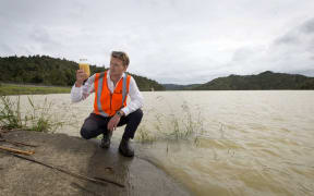 Watercare's Joseph Chaloner Warman with a water sample in the Hunua Ranges.