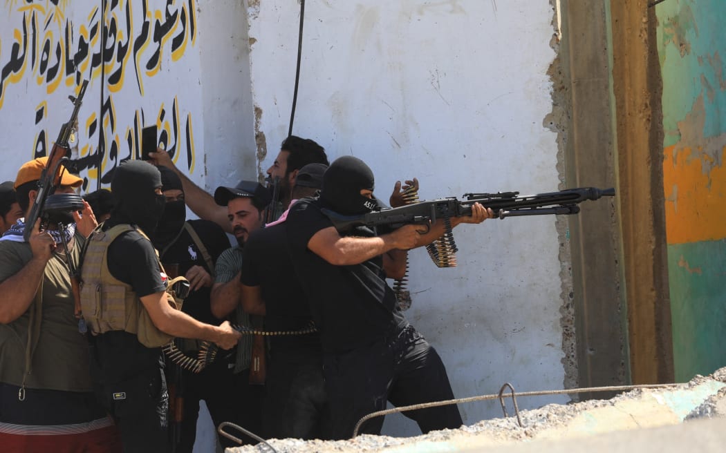 Supporters of Iraqi cleric Muqtada al-Sadr clash with security forces with heavy weapons at Green Zone after Sadr supporters stormed the Presidential Palace in Baghdad, Iraq on 30 August, 2022.