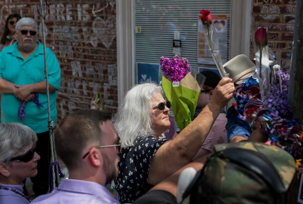 Susan Bro, mother of Heather Heyer, lays flowers in Charlottesville, Virginia, in memory of Heyer James Alex Fields, Jr., a Nazi sympathizer, was found of her murder on December 7, 2018  in  Charlottesville, killing 3 Heyer. AFP