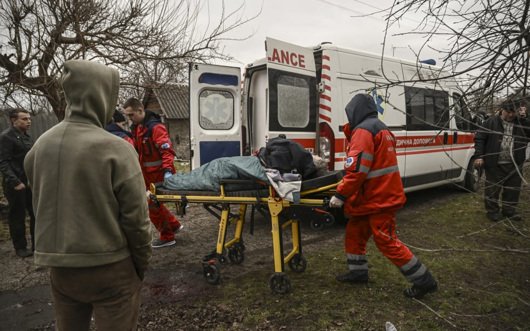 Paramedics evacuate a heavily injured man after a cluster bomb strike in Kramatorsk in the Donbas region on March 18, 2023.