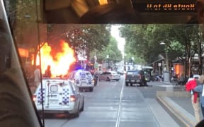 One person has been killed and two others have stab wounds after they were attacked in Bourke Street, where a car was also on fire.