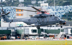 A New Zealand Air Force NH90 helicopter carrying Britain's Prince Harry with his wife Meghan, the Duchess of Sussex, takes off from Wellington on October 29, 2018 heading for Tasman. - Prince Harry and Meghan arrived in Wellington on October 28 to a traditional Maori welcome, an official reception disrupted by a fire alarm and a rock star reception during a public walkabout. (Photo by Marty MELVILLE / AFP)