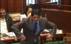 Fiji's finance minister Aiyaz Sayed-Khaiyum makes the gesture towards opposition MPs in parliament.