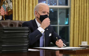 U.S. President Joe Biden prepares to sign a series of executive orders at the Resolute Desk in the Oval Office just hours after his inauguration on January 20, 2021 in Washington, DC.