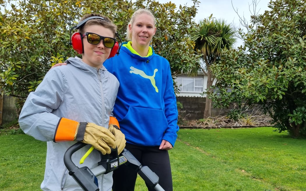 Eleven-year-old Kayden Wallis-Potroz with his mum Chalsey Potroz who transports him to his lawn mowing clients.