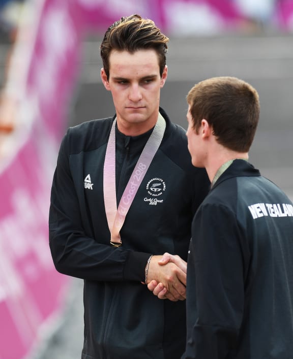 New Zealand's Samuel Gaze with the gold medal shakes hands with Anton Cooper after the medal ceremony.