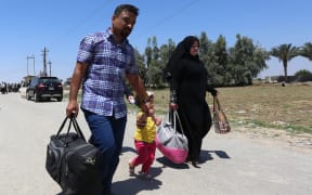 Residents from the city of Ramadi flee their homes as Islamic State tightened its siege on the city