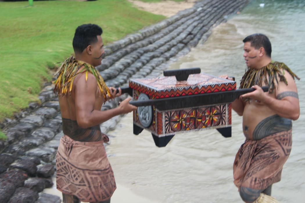 The new quarter coin is transported by traditional canoe