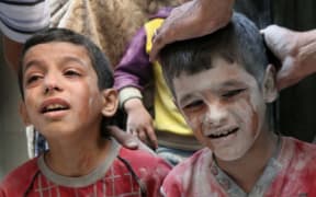 Syrian boys cry following Russian air strikes on the rebel-held Fardous neighbourhood of the northern embattled Syrian city of Aleppo.