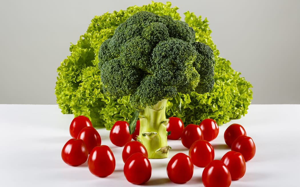 broccoli, green lettuce and cherry tomatoes on a table
