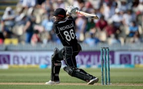 New Zealand's Henry Nicholls hits a boundary during the 4th One Day International cricket match against India.