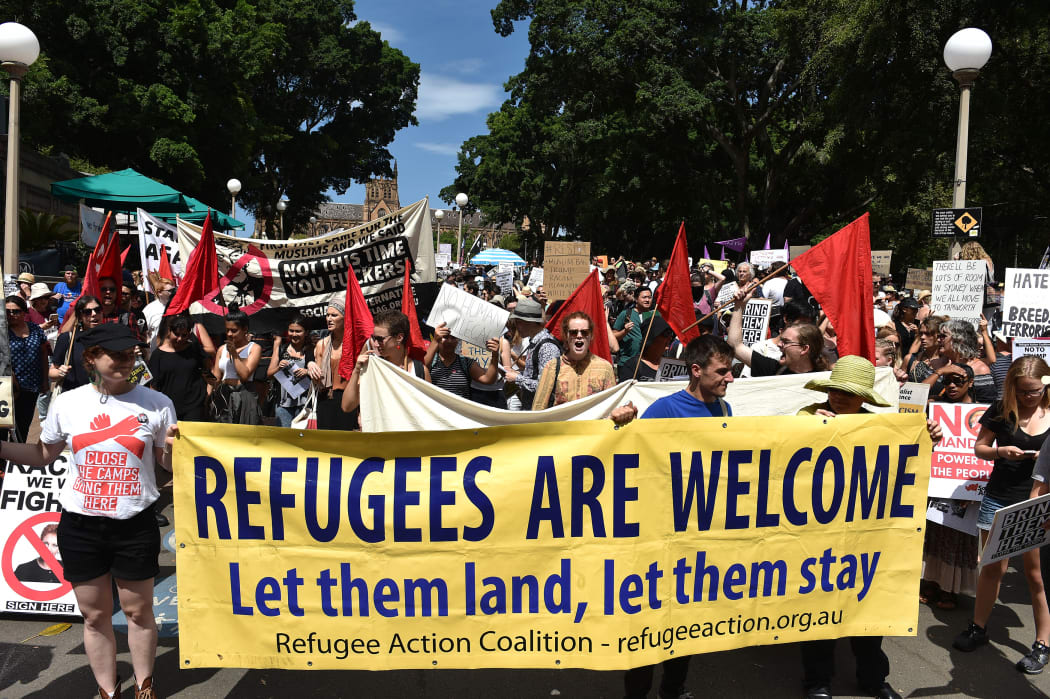 A large number of people from different walks of life holding banners and placards marched to the US consulate protesting against Trump's travel ban policy and demanded Australian government to settle all the refugees and asylum seekers in the county.