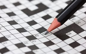 Crossword puzzle and pencil