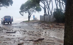 Debris from the storm surges on Ōrewa Beach, north of Auckland.