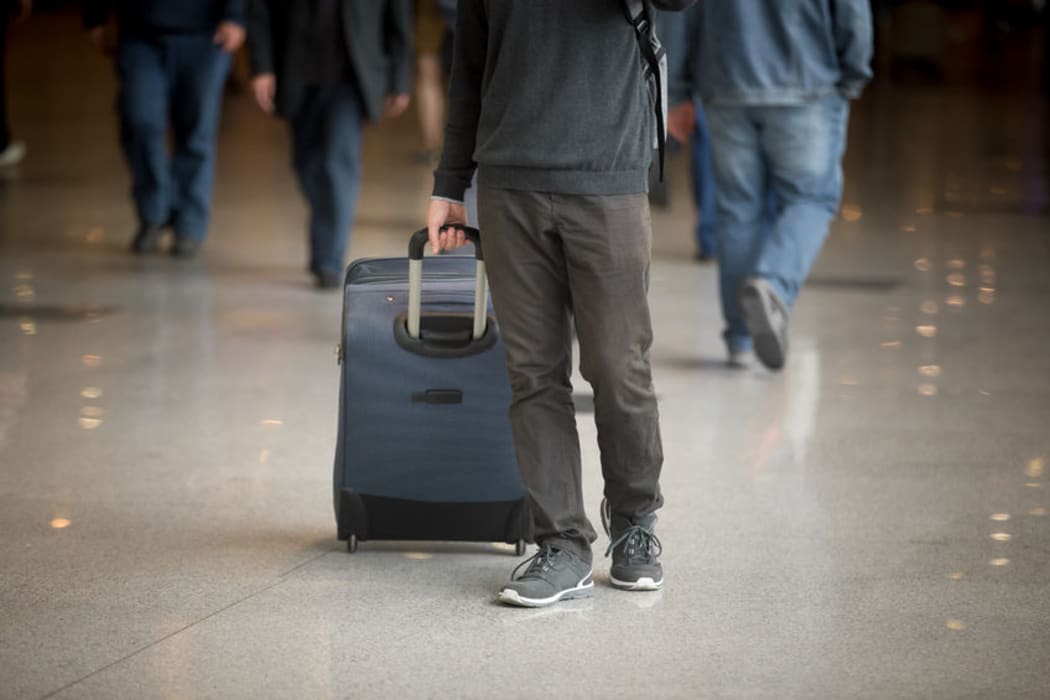 Man pulling suitcase