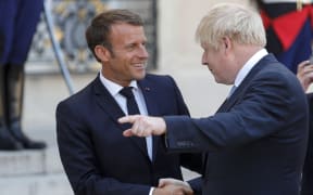 French President Emmanuel Macron shakes hands with UK Prime Minister Boris Johnson after a meeting at The Elysee Palace in Paris on 22 August, 2019.