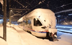 A commuter train  at the station of Berchtesgaden, southern Germany, on January 10, 2019, where rail transport stopped due to heavy snowfalls.