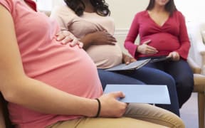 Pregnant women meeting at ante-natal class - stock photo