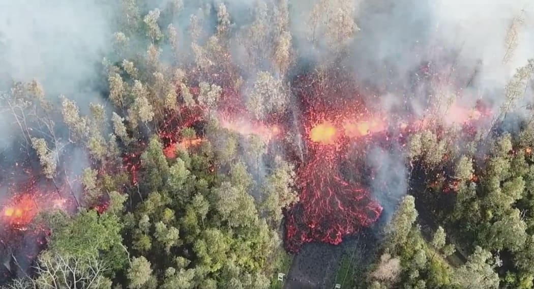 Still from drone footage of lava flow in Leilani Estates, Hawaii