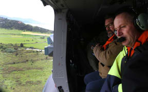 New Zealand Prime Minister John Key (R) inspects earthquake damage from a helicopter near Kaikoura.