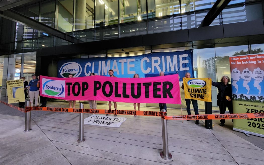 A small number of Extinction Rebellion protesters holding signs saying 'climate crime' and 'top polluter' blocked entrances to Fonterra's head office in central Auckland on Thursday 23 February 2023.