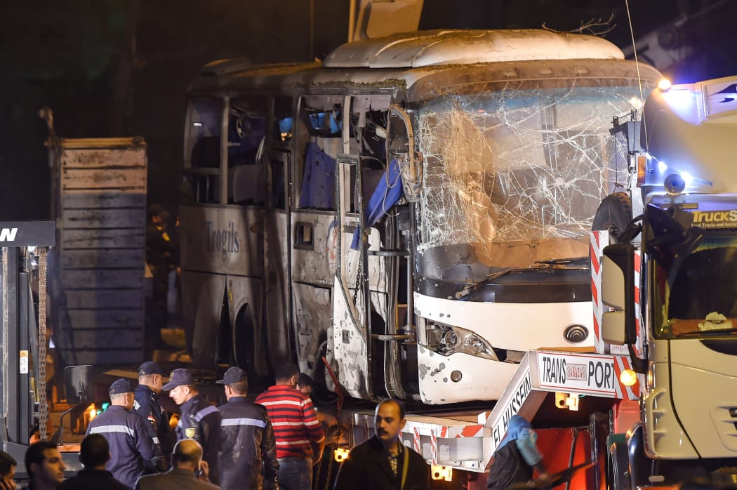 This picture taken on December 28, 2018 shows a tourist bus which was attacked being towed away from the scene, in Giza province south of the Egyptian capital Cairo.