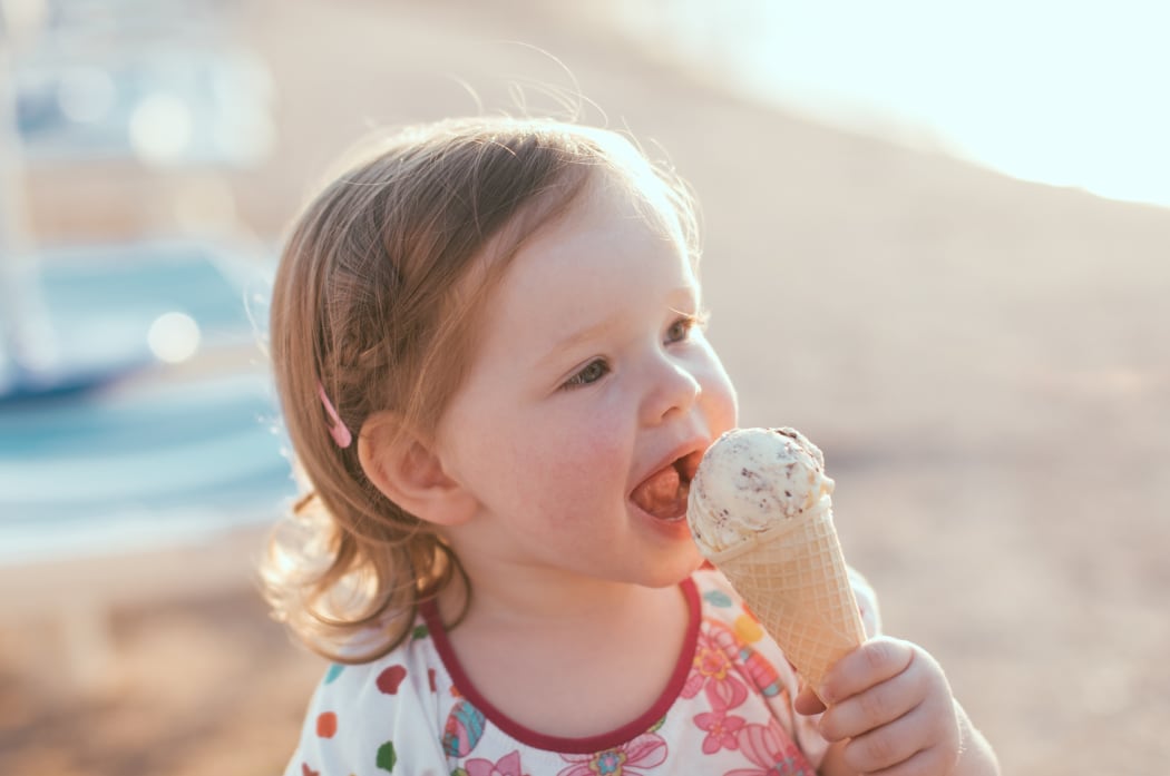 Cute little girl eating ice-cream