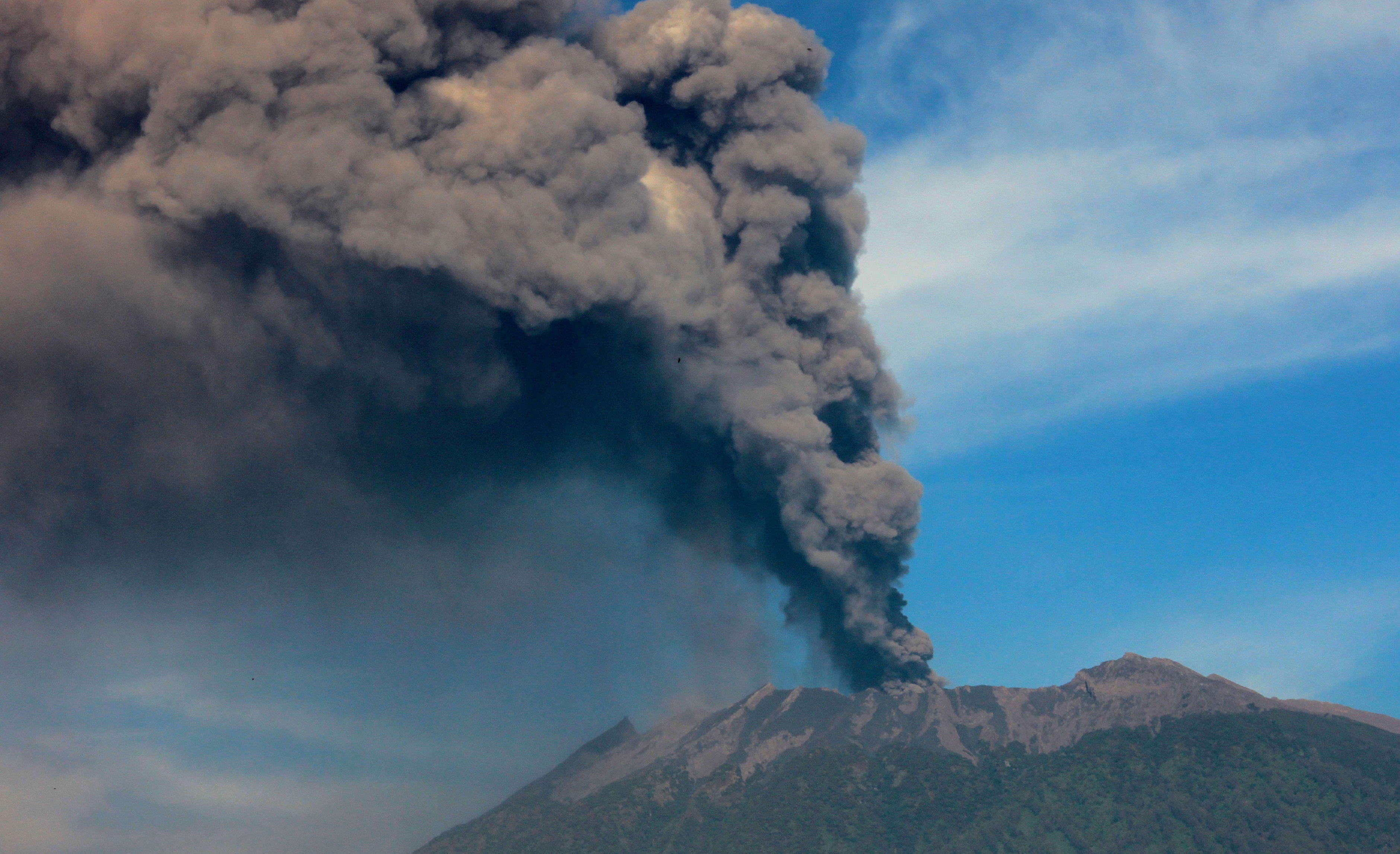 Mount Raung emits a column of ash and steam on 12 July 2015.