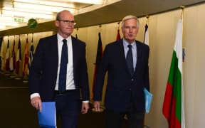 Irish Foreign Minister Simon Coveney (left) arrives to meet with European Union's chief Brexit negotiator Michel Barnier at the EU Commission headquarters in Brussels yesterday.