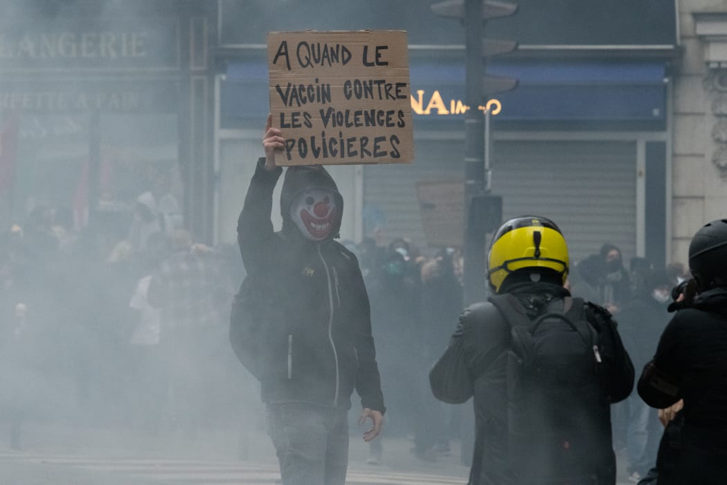 "When will there be a vaccine against police violence?" reads a French protester's placard against the draft Global Security Law.