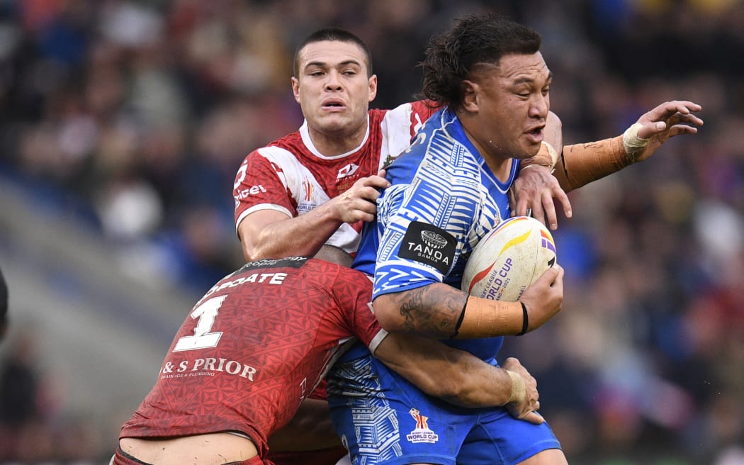 Samoa's Josh Papali'i is tackled during the 2021 rugby league World Cup men's quarter-final match between Tonga and Samoa at Halliwell Jones Stadium in Warrington.