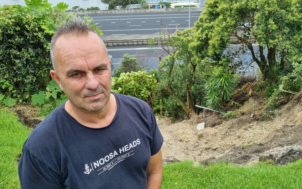 St Mary's Bay resident Karl Browne with the slip on his property that opened up after heavy rains caused flooding and damage throughout Auckland. 30 January, 2023