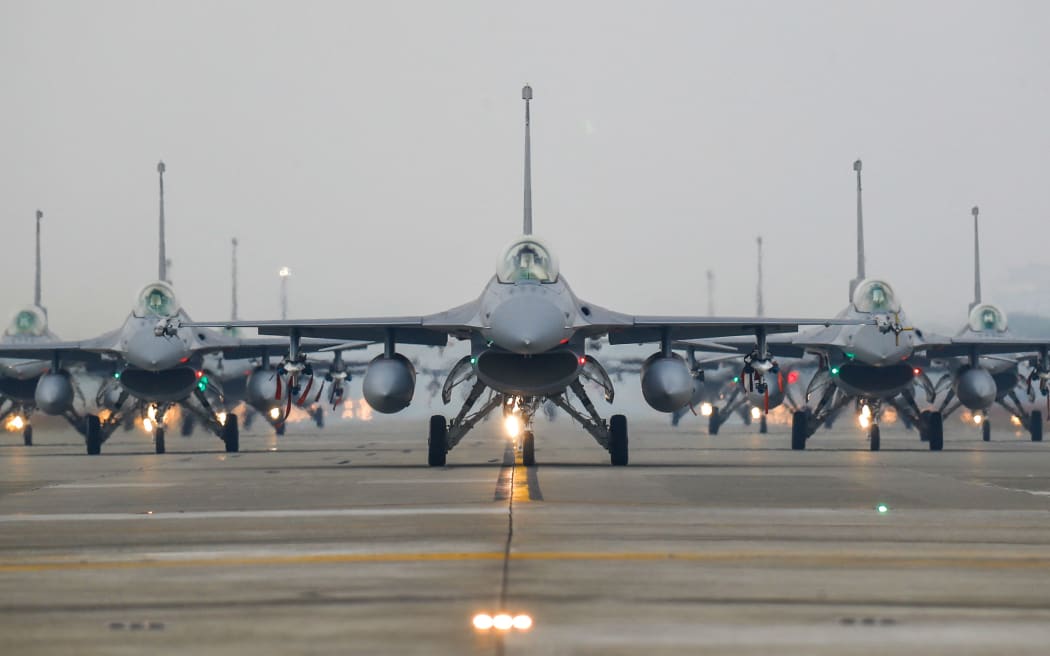 F-16V jet fighters taxi on the runway at the Air Force base, as the Taiwanese military holds a drill for preparedness enhancement ahead of the Chinese New Year, amid rising threats from China, in Chiayi, Taiwan, on Jan 5, 2022. Taiwan has been facing intensifying threats from Beijing including a record breaking number of PLA warplanes flying into its ADIZ, while the US has been approving more arms sales to Taipei. (Photo by Ceng Shou Yi/NurPhoto) (Photo by Ceng Shou Yi / NurPhoto / NurPhoto via AFP)