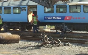 Mangled pieces of the train are removed at the Wellington station.