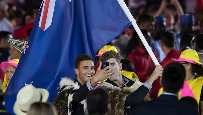 New Zealand flag bearers Blair Tuke and Peter Burling take a selfie during the opening ceremony at Maracana Stadium.